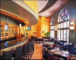 Keywords: luxury hotel 

Description: A luxury hotel with wooden tables and chairs.