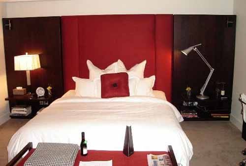 Lakes and mountains create a perfect setting for The Spire Hotel's scenic bedroom with a bed and red headboard.