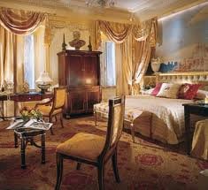 An amazing destination for indulgence with a large bed and a large painting on the wall.