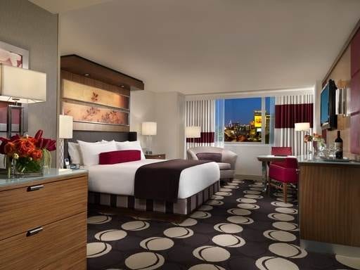 A luxurious hotel room at the MGM Mirage in Las Vegas, Nevada featuring a comfortable bed and a high-definition television.