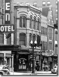 A photo of a hotel sign in black and white on a street in Indianapolis.