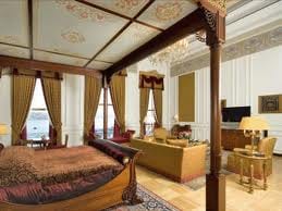An ornately decorated bedroom with a four poster bed fit for a Sultan at Grand Sultan Suite, The Ciragan Palace Hotel Kempinski.