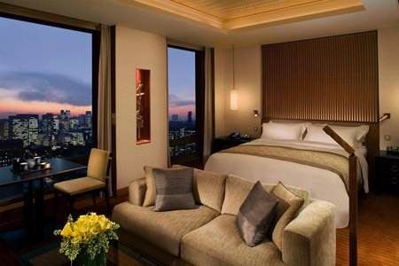 A shining landmark in Tokyo, The Peninsula Tokyo offers stunning accommodations with city views at dusk.