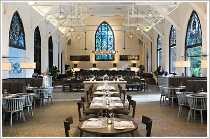 A restaurant with tables and chairs in a church.