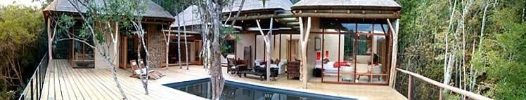 An aerial view of a wooden house with a pool, rejuvenated with Trogon House and Forest Spa.