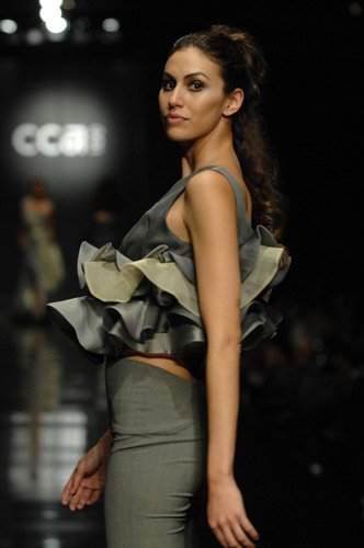 A model walks down the runway in a grey outfit at San Francisco.