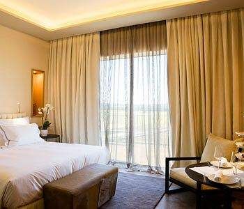 A bed or beds in a room at Valbusenda Hotel Resort & Spa.