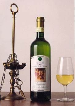 A bottle of Vernaccia di San Gimignano's white wine and a glass on a table.