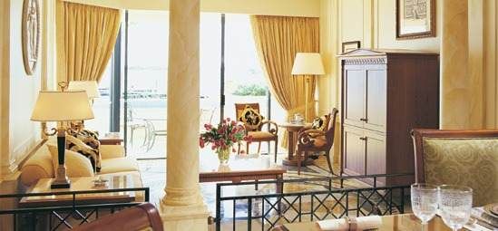 A living room with a dining table and chairs at Palazzo Versace on the Gold Coast.