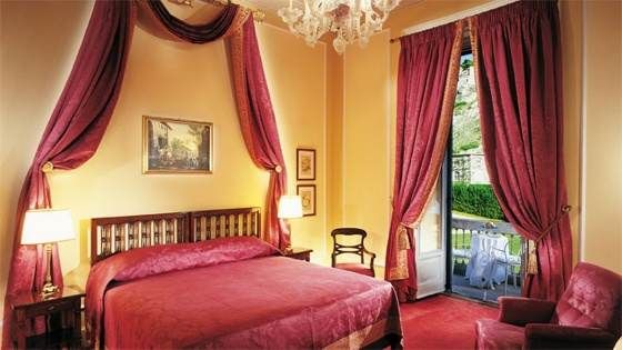 A bedroom with a balcony.