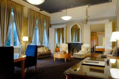 A large living room with a fireplace and large windows, offering an escape into the top floor of The Westin Sydney to touch the Sydney skyline.