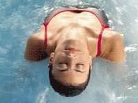 A woman enjoying a relaxing day at the Zoetry Wellness & Spa Resort pool.