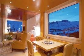 Experience the heavenly Swiss style at the Tschuggen Grand Hotel, offering a living room with mountain views.