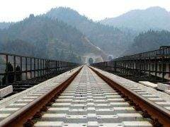 A train track amidst mountains.