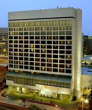 A large hotel in the middle of a city at night: Sheraton Crystal City Hotel.