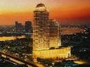 An aerial view of a city at dusk featuring Lebua at State Tower.