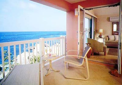 A balcony with a view of the ocean in Bermudian style at The Reefs.