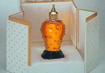 Caron's Poivre perfume bottle in a box with gold polka dots.