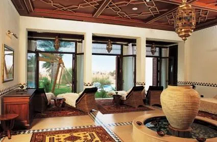 Mingle with Arabian Oryx while experiencing the Bedouin lifestyle in Al Maha Desert Resort & Spa, featuring a fireplace and water fountain in the living room.