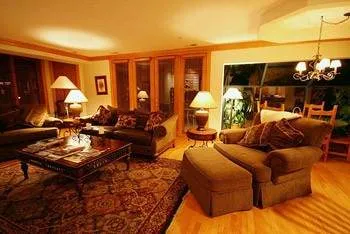 A modern living room with wood floors and a fireplace in Beaver Creek Lodge.