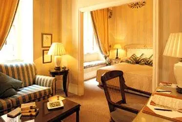 A hotel room with yellow walls and a bed offering cultural allure.