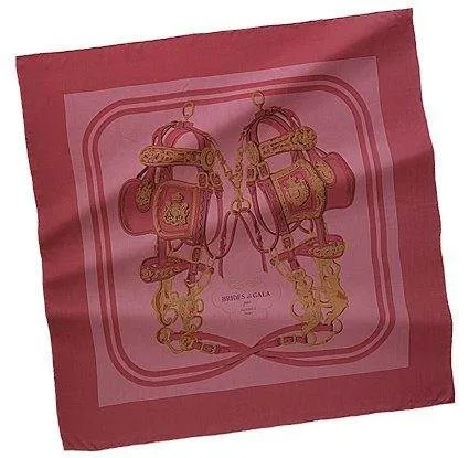 A pink and gold silk scarf with shoes on it.