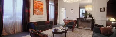 A living room with large windows showcasing the serene beauty of Geneva.