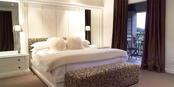 A bedroom with a bed and a dresser, ideal for relaxation.