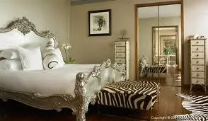 The G Hotel is the Best Place to Organize a Grand Wedding with an ornate bed and zebra print rug.