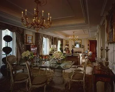 An ornate living room with table and chairs.