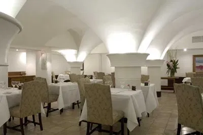 The Cellar - Dublin, Ireland: An arched dining room with white tables and chairs.
