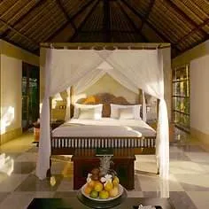 Explore a peaceful isle with a four poster bed and a coffee table.