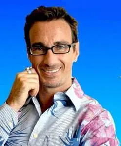 Celebrity Hair Stylist Stuart Phillips donning glasses and a Hawaiian shirt.