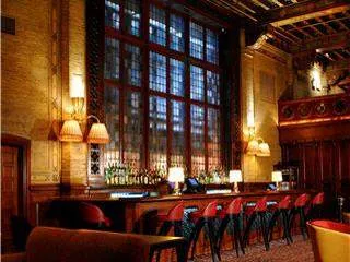 A large room with a bar and chairs, perfect for those who wouldn't want to move in.