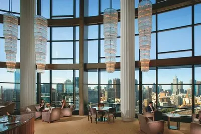 The lobby of Melbourne's Crown Towers hotel with large windows overlooking a city.