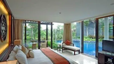 A tropical bedroom with an ocean view from Sanya Resort & Spa.