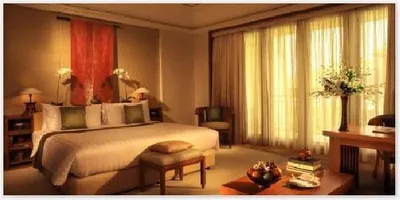 Indulge yourself into the Majapahit culture of a hotel room with a bed and a large window at The Dharmawangsa Jakarta.