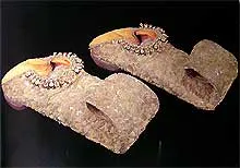 A pair of sandals adorned with intricate beaded patterns.