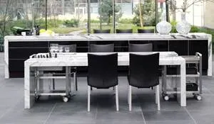 A black and white kitchen with a designer dining desk.