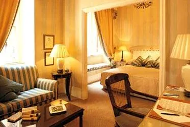 A hotel room with yellow walls and a bed offering cultural allure.