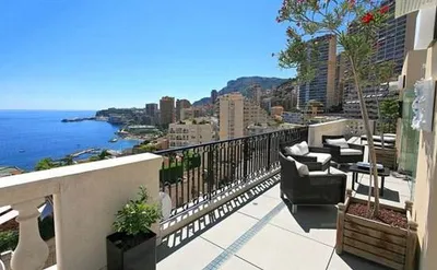 A Monte Carlo dream home with a balcony overlooking the ocean.