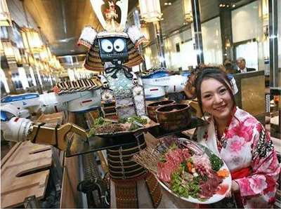 A woman served by a robot waiter at Hajime Restaurant.