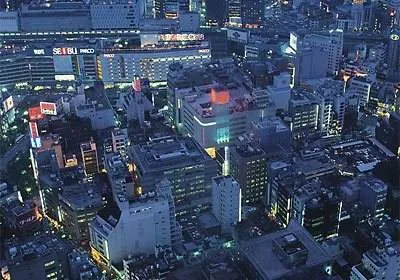 An aerial view of a city at night with stunning lights and scenery.