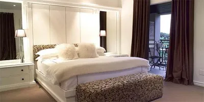 A bedroom with a bed and a dresser, ideal for relaxation.