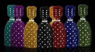 A group of different colored bottles with rhinestones on them, featuring 'Le Billionaire Champagne': The Ultimate Taste.