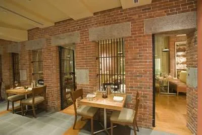 A restaurant with brick walls and tables in Boston, MA.