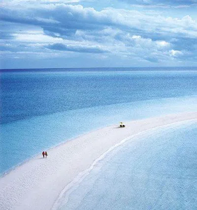 A private island vacation with a white sand beach and boat on Musha Cay.