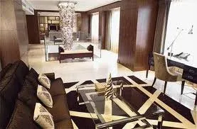 A living room with brown and black furniture at Hotel Okura Amsterdam.