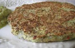 A plate with a burger and guacamole on it, the most expensive pancake in the world.