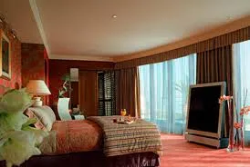 A luxurious bed with a breathtaking ocean view at the Royal Penthouse Suite of President Wilson Hotel.
